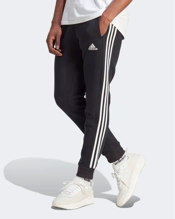 Prodotto: ADIDAS - PANTALONI ESSENTIALS FLEECE 3-STRIPES TAPERED CUFF - IB4030